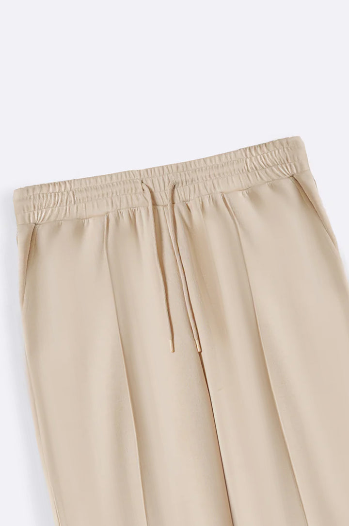 BEIGE CURVE PLEATED NEOPRENE TROUSERS