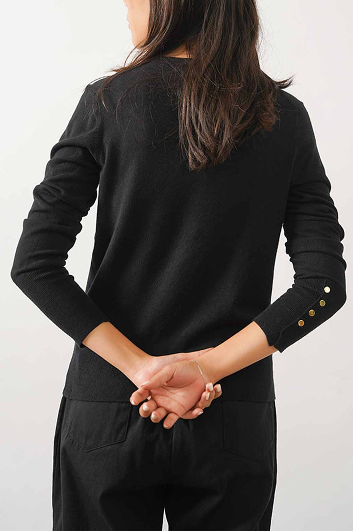 BLACK JUMPER WITH SLEEVE BUTTONS.